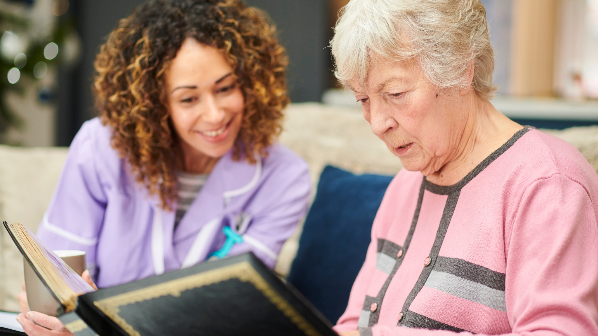 elderly with Dementia nurse showing her book
